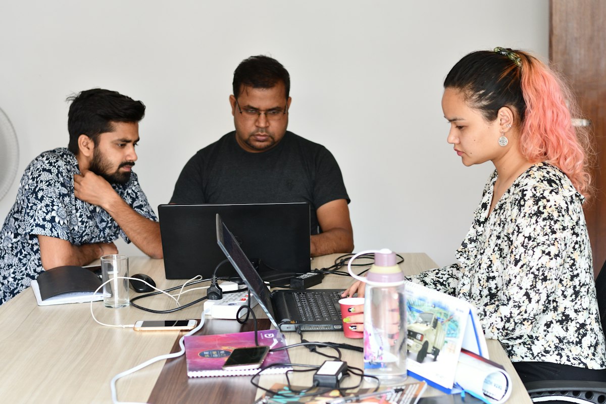 An Indian team working through leads together on a laptop