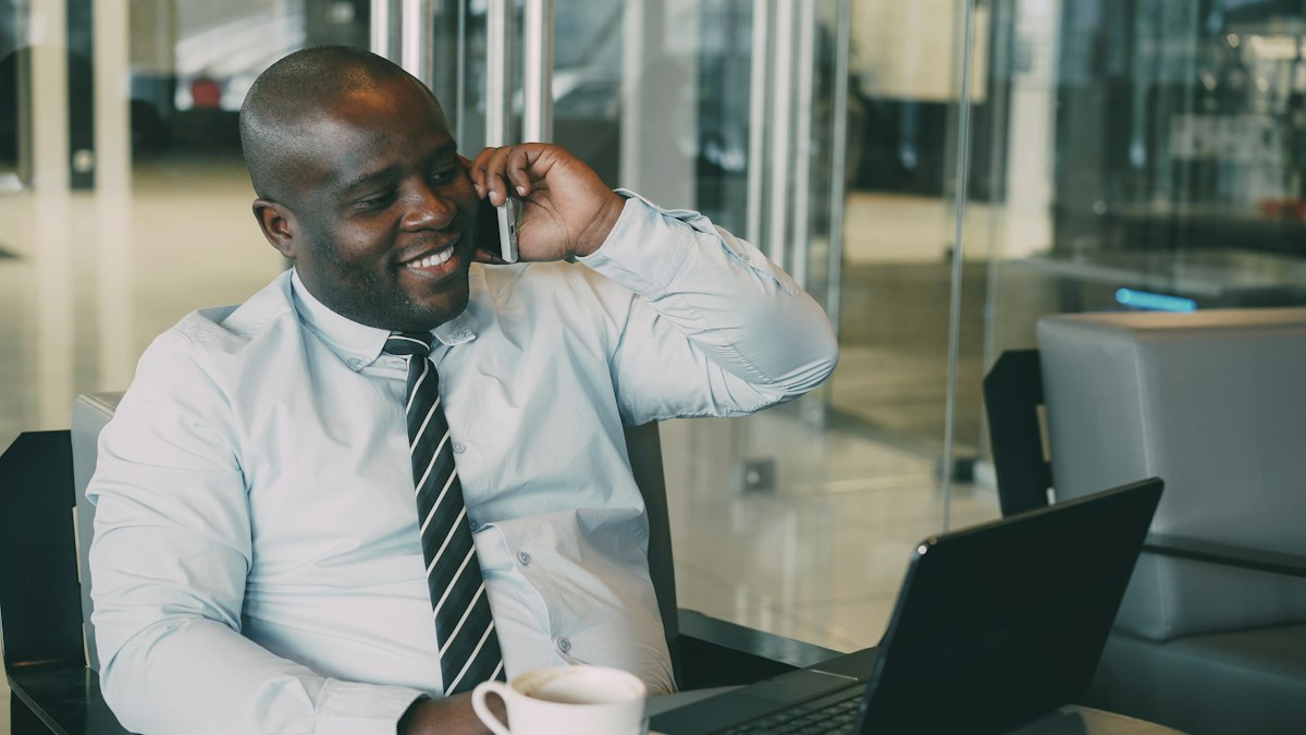 A businessman on a phone call at his desk