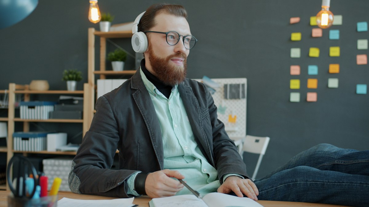 A professional in a headset taking notes during a call