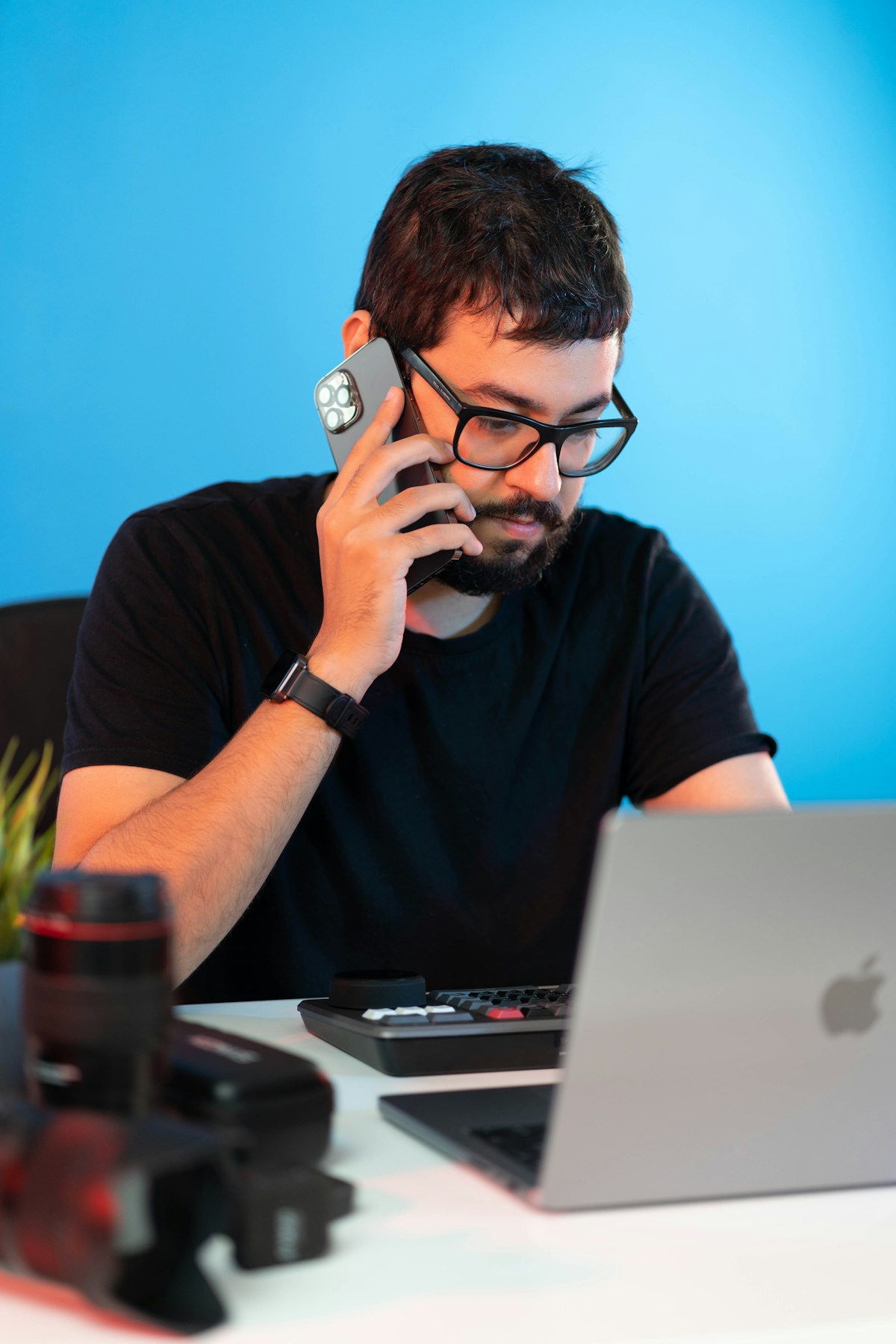 A professional on a phone call at his laptop