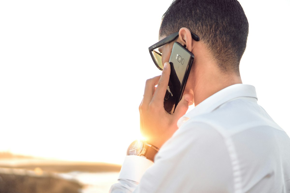 A professional on a phone call in the sunlight